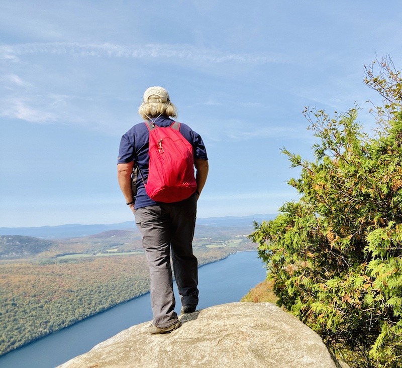 hiker standing on cliff on Mt. Pisgah