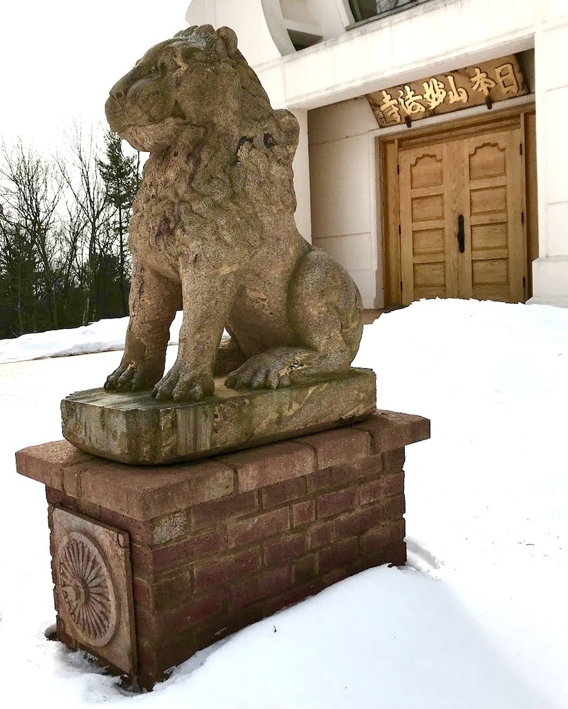 lion statue in front of temple-outdoor spiritual retreat