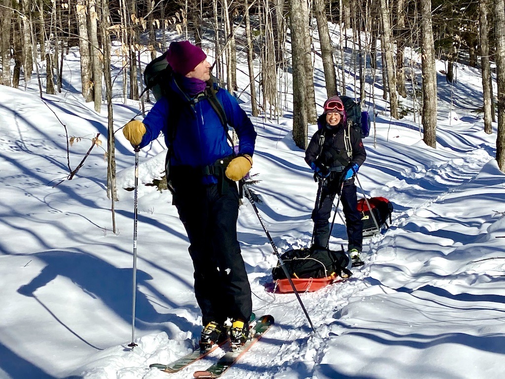 2 skiers with sleds-cross country skiing Adirondacks