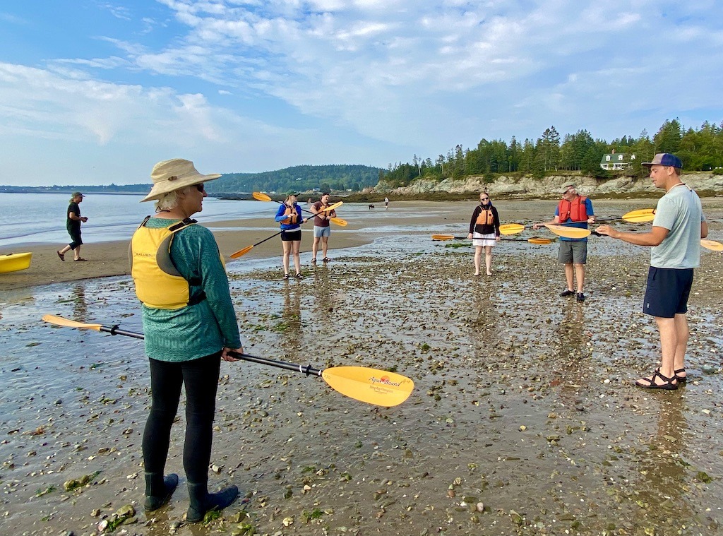 people with paddles while sea kayaking on Grand Manan