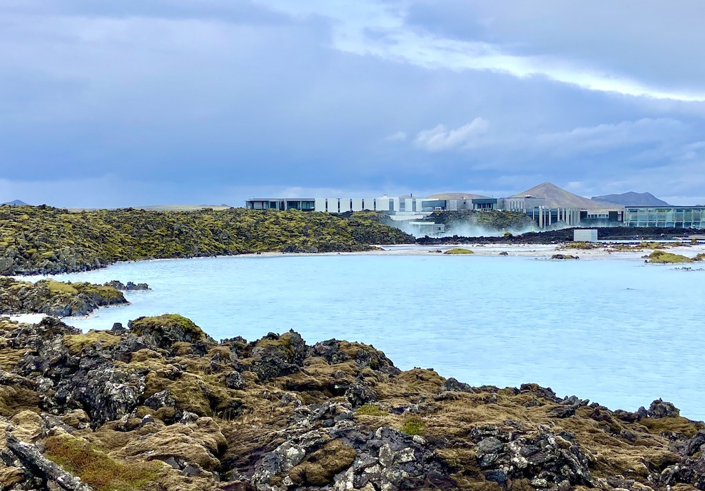 blue colored water and building-outdoor adventures in Iceland