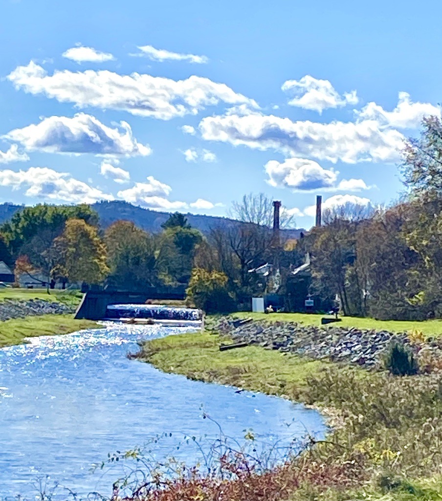 dammed river and fluffy clouds on one of the best bike trails in Western Massachusetts
