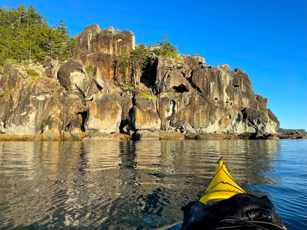 Sea kayaking in the Whitsunday Islands.Rocks and a yellow kayak
