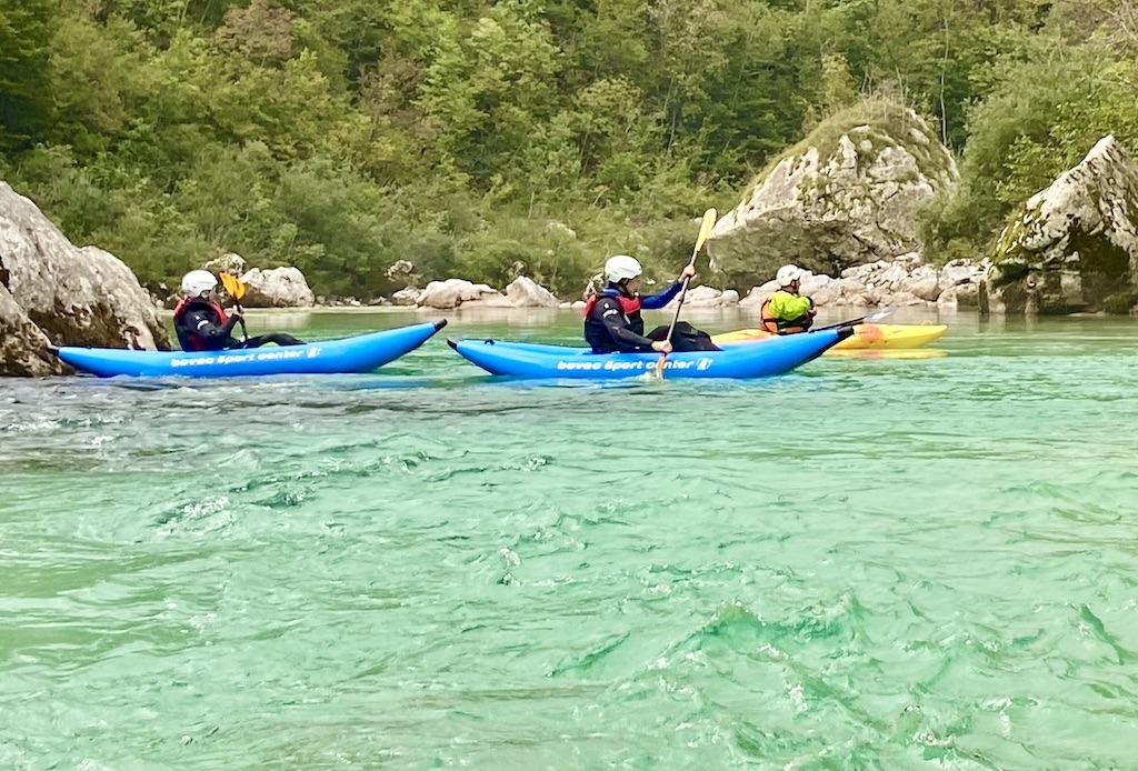 Whitewater kayaking on the Soca River in blue kayaks