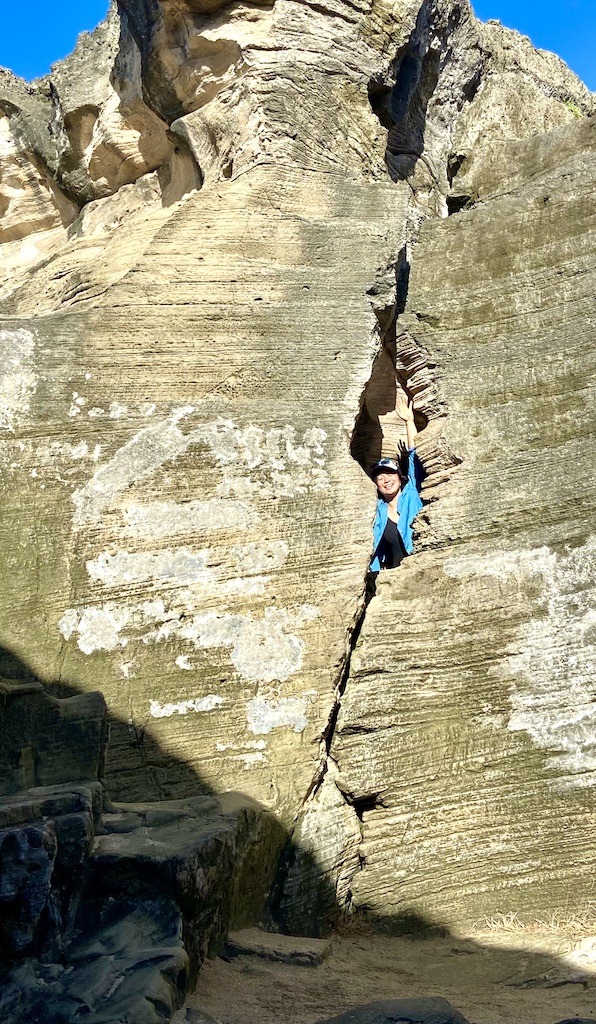 person in crack of cliff wall-Outdoor Adventures Arecibo