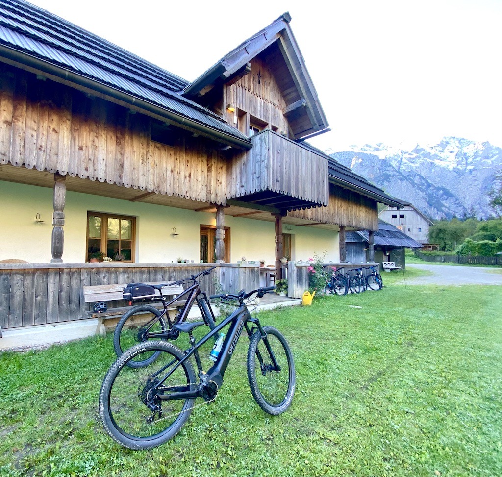 2 e-bikes in front of building with mountains in the background for outdoor adventures in the Logar Valley
