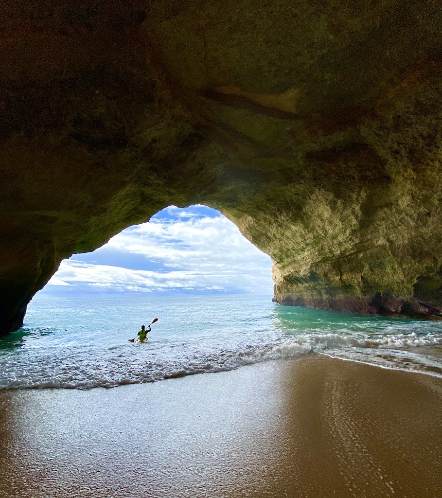 sea kayaker leaving cave while sea kayaking Benagil Cave