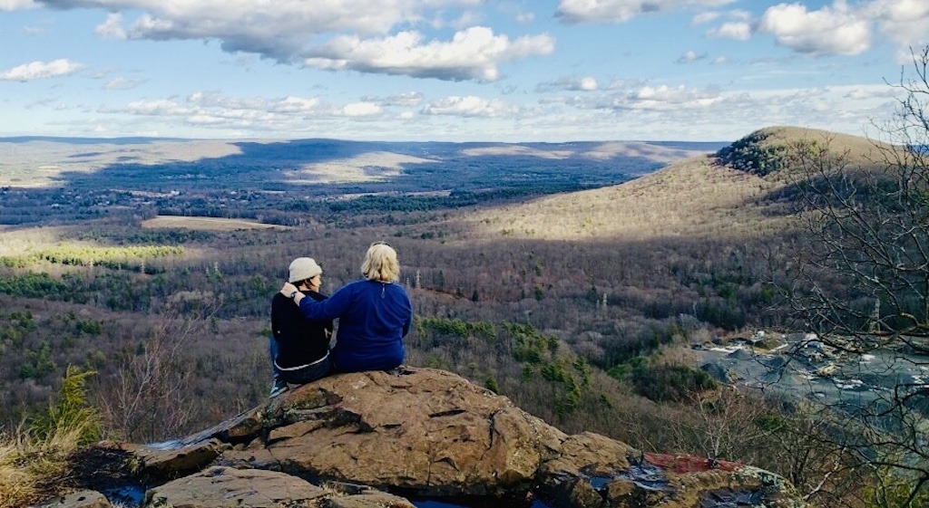 two people sitting on top of mountain-best hikes Holyoke Range
