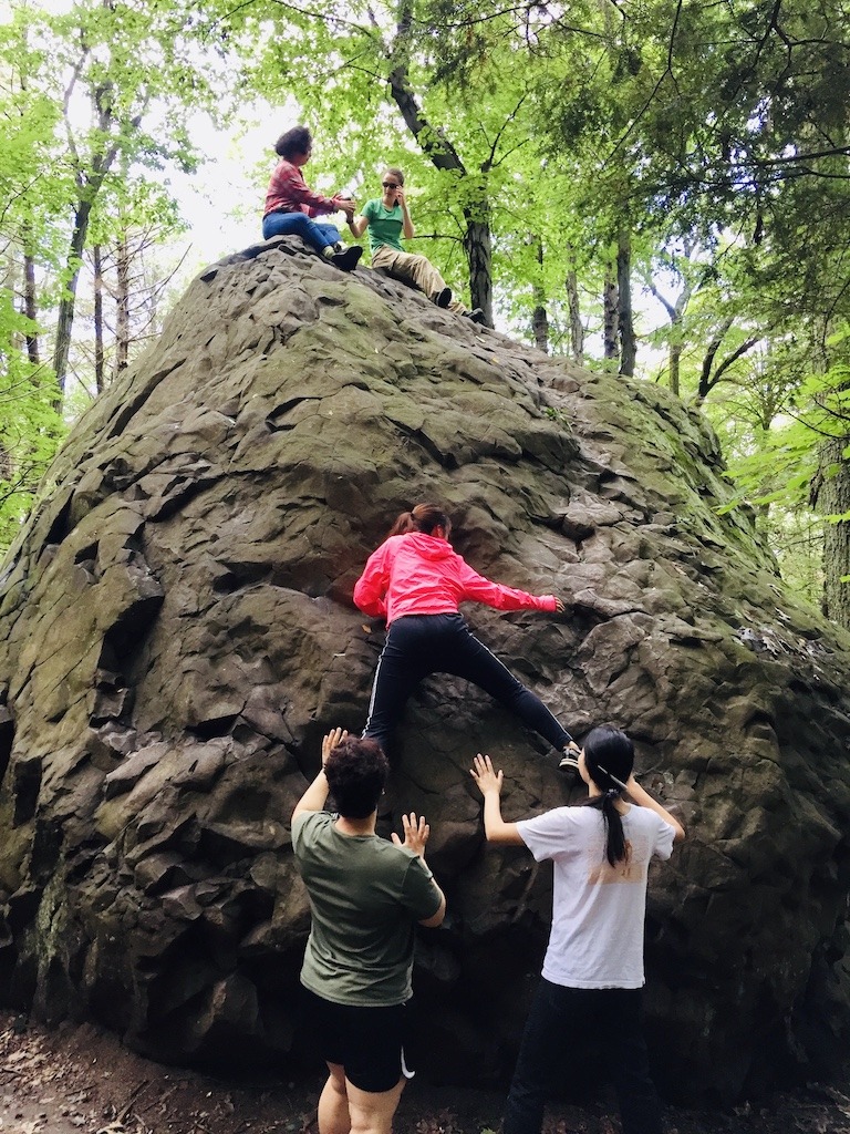 people climbing large boulder-best hikes Holyoke Range