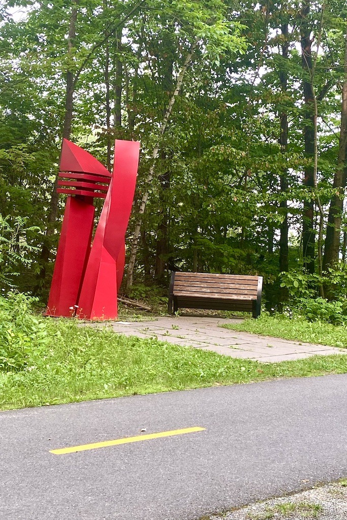 bike trail with red structure and bench