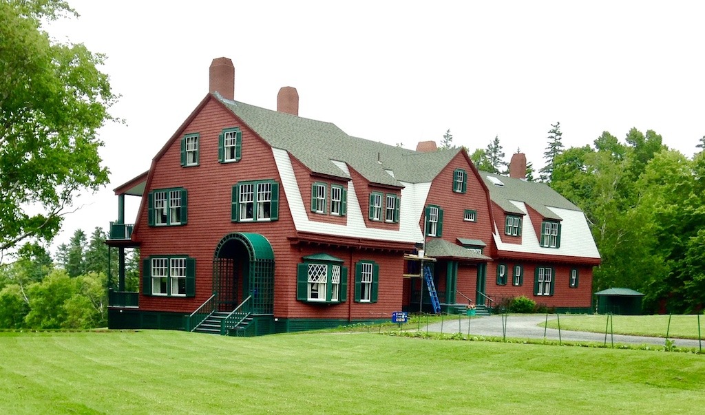 Large red house on green lawn