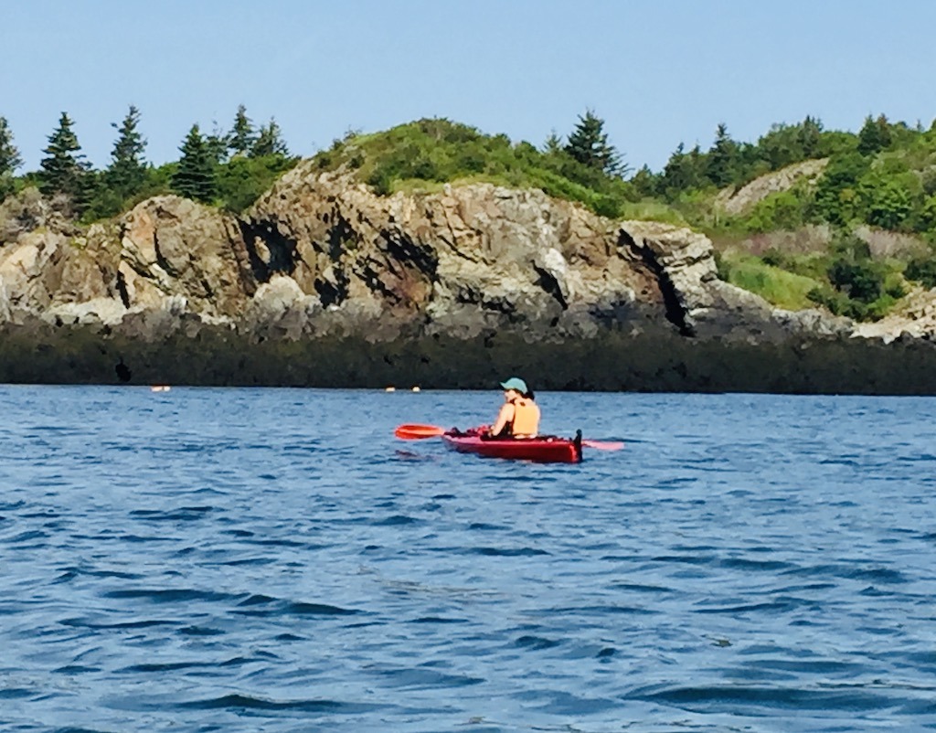 kayaker in red boat-Downeast Maine outdoor adventures