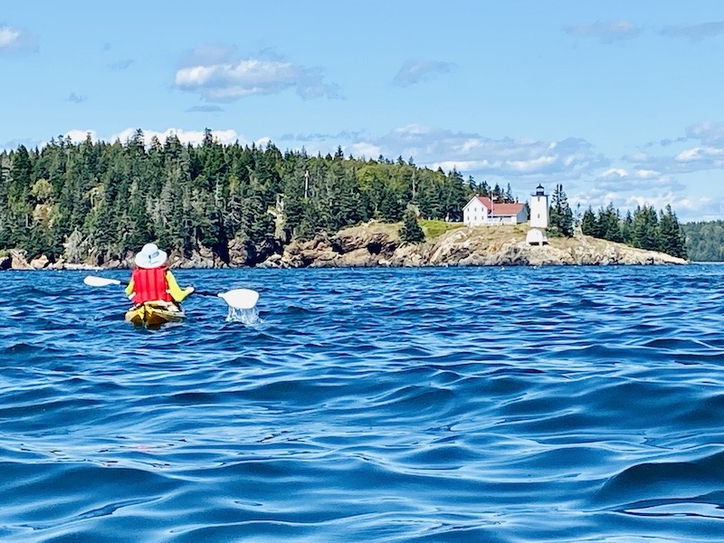 sea kayaker and lighthouse-Downeast Maine outdoor adventures