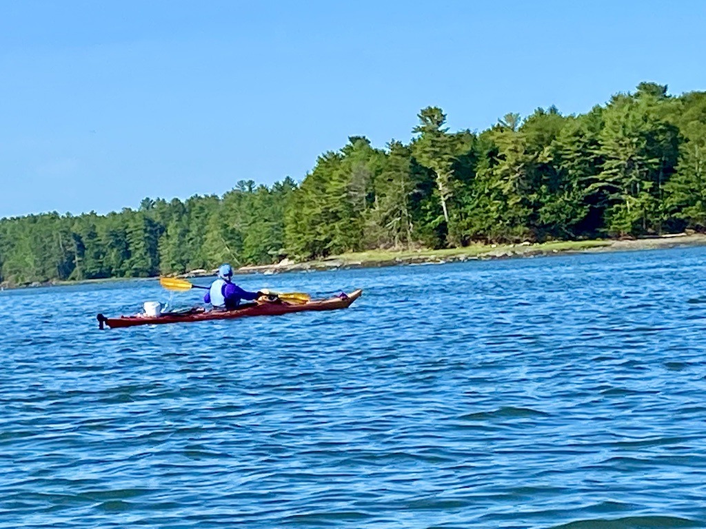 sea kayaker with red boat-Downeast Maine outdoor adventures