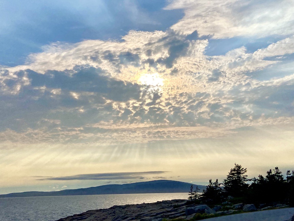 sun rays over ocean and mountain-Downeast Maine outdoor adventures