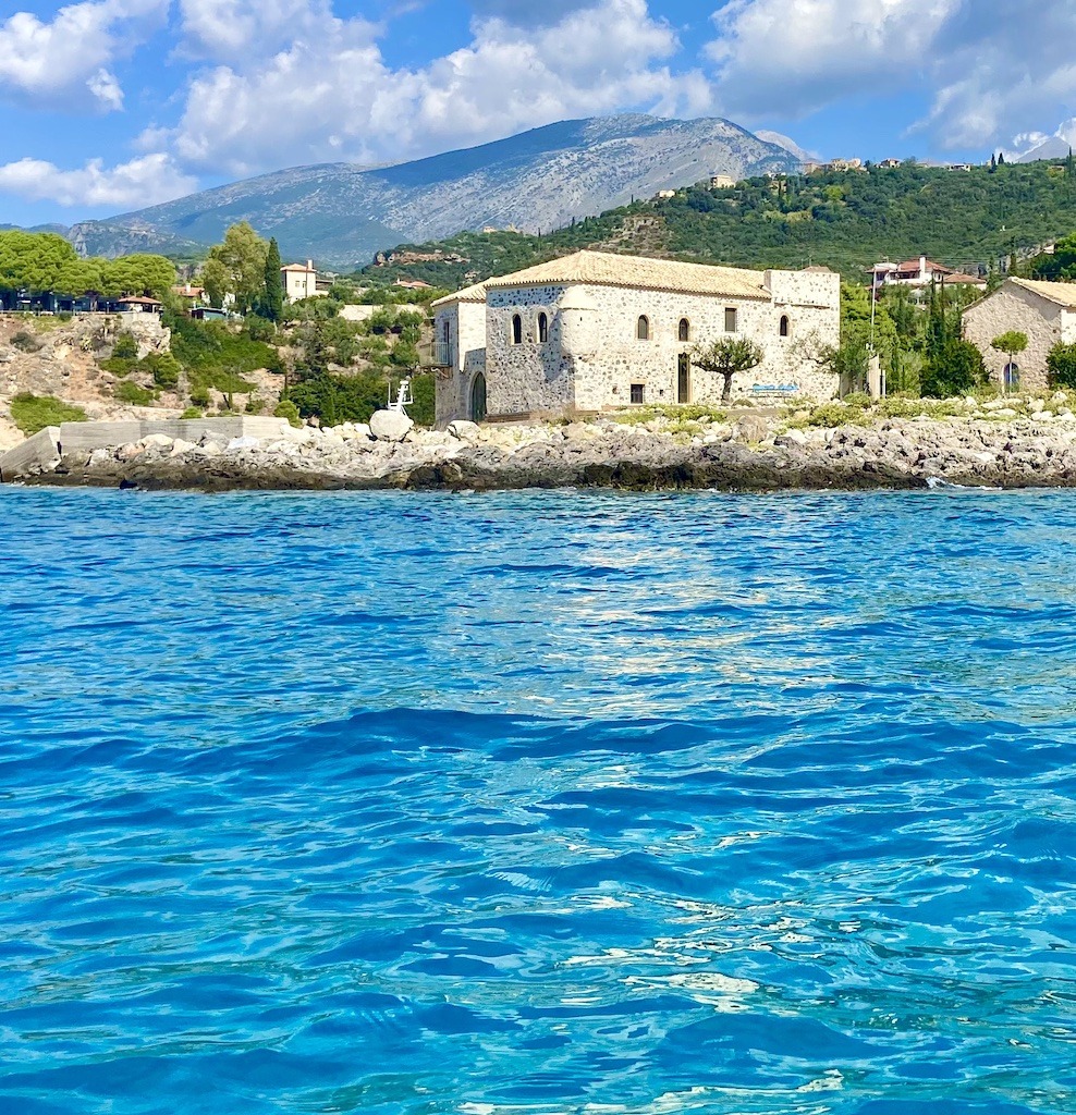 mountain with old buildings and blue water-Sea Kayaking on the Mani Peninsula