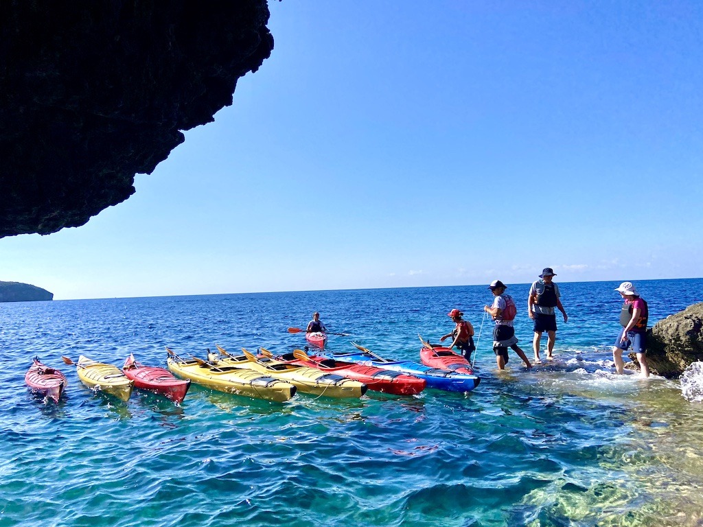 Kayaks lined up outside sea cave-Sea Kayaking on the Mani Peninsula