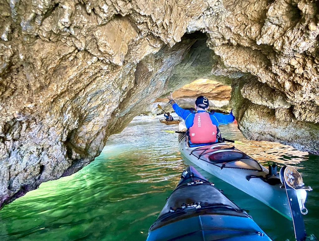 entering a cave with green water-sea kayak on Kefalonia