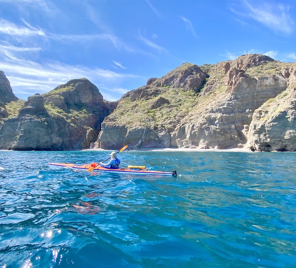 orange sea kayak on turquoise water- Sea Kayaking in Baja
