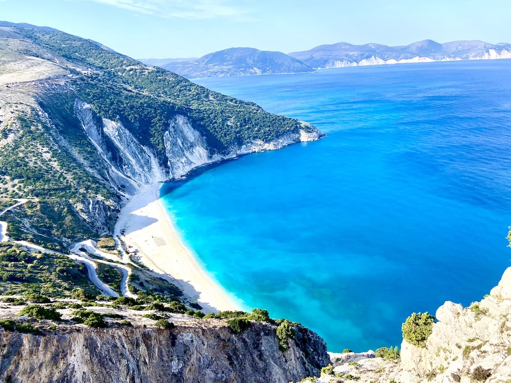 beach with blue water and mountains-Outdoor Adventures of Kefalonia