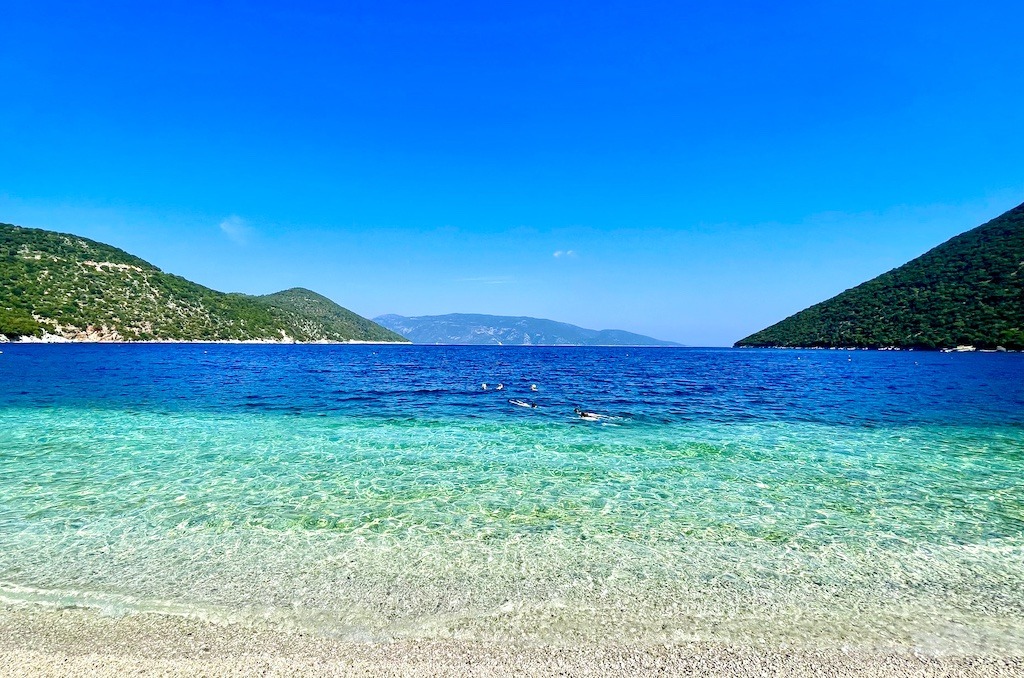 beach with many shades of blue water surrounded by mountains-Outdoor Adventures of Kefalonia