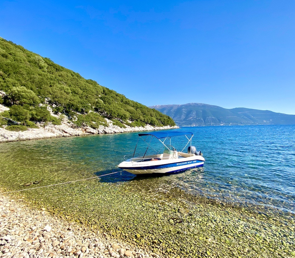 motor boat moored in blue water-Outdoor Adventures of Kefalonia