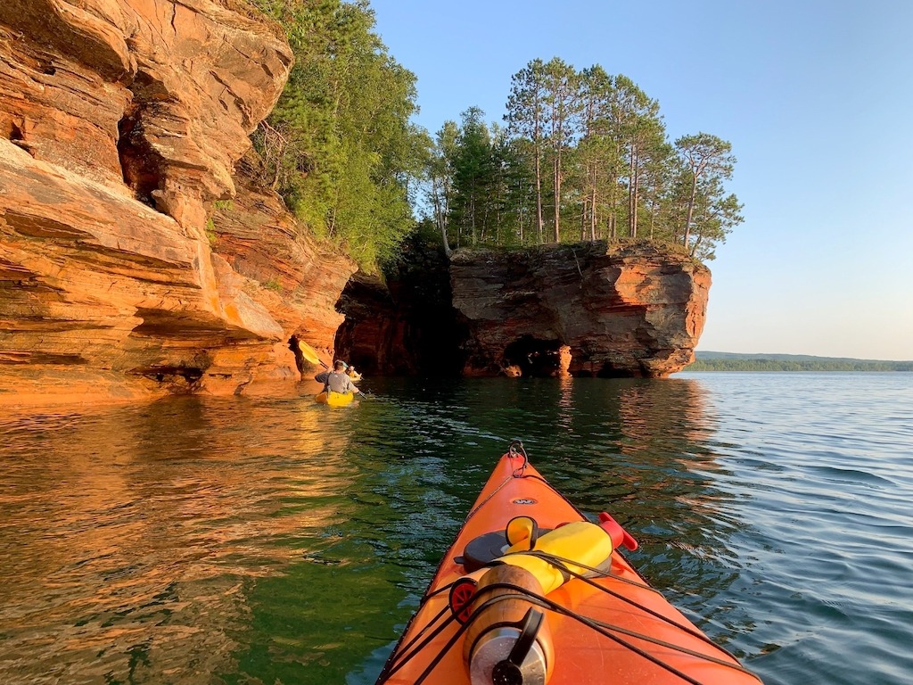 orange kayak and cliffs-best kayaking day trips in the US