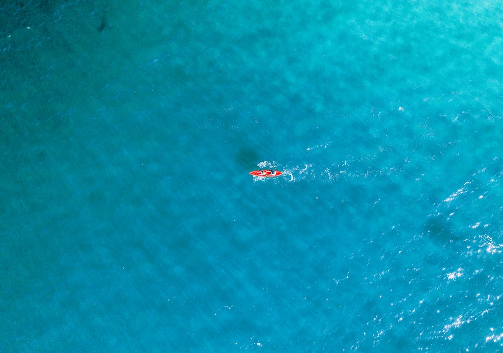 red kayak on blue water-best kayaking day trips in the US