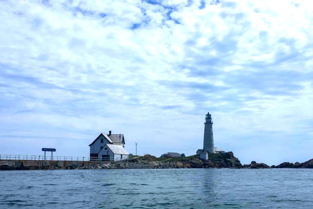 white house and lighthouse on water-best kayaking day trips in the US