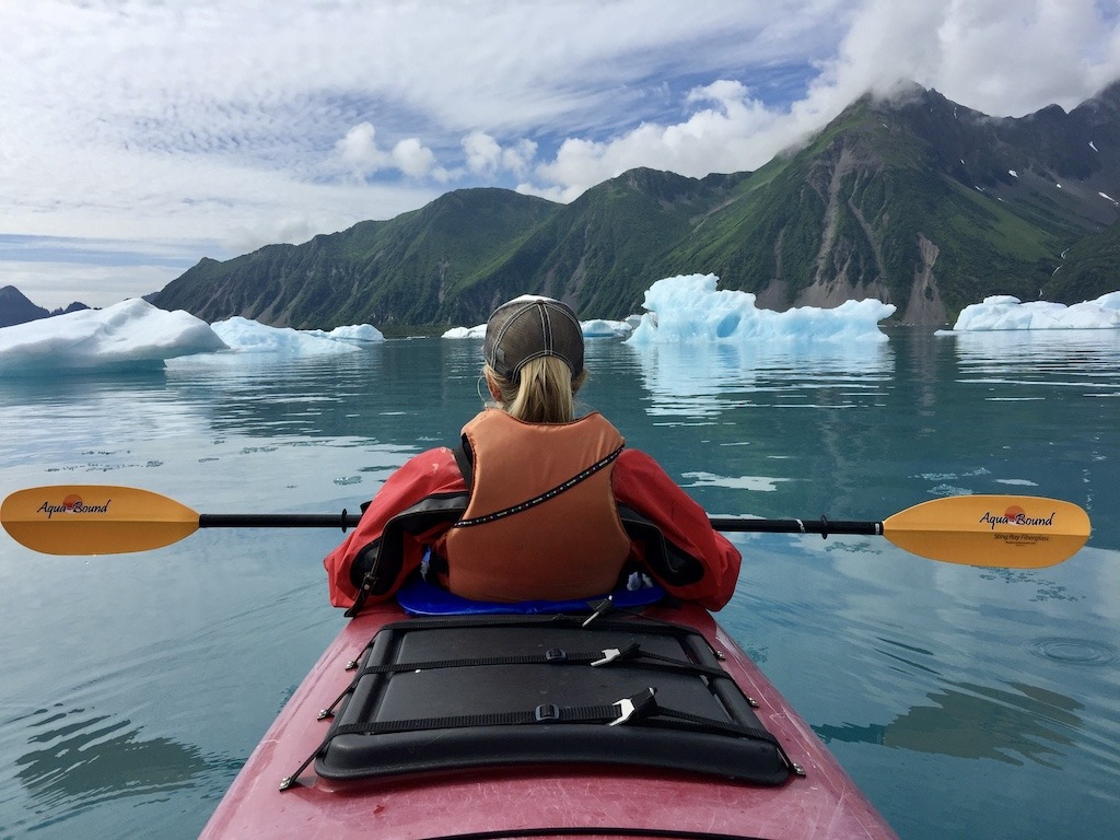 red kayak in between icebergs-best kayaking day trips in the US