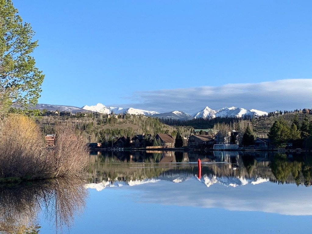 mountains reflecting in lake-best kayaking day trips in the US