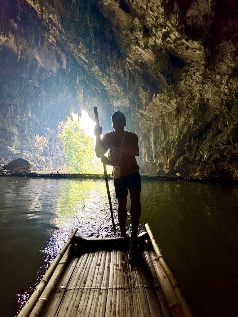 Guide of a bamboo raft in a cave-Outdoor Adventures in Pai