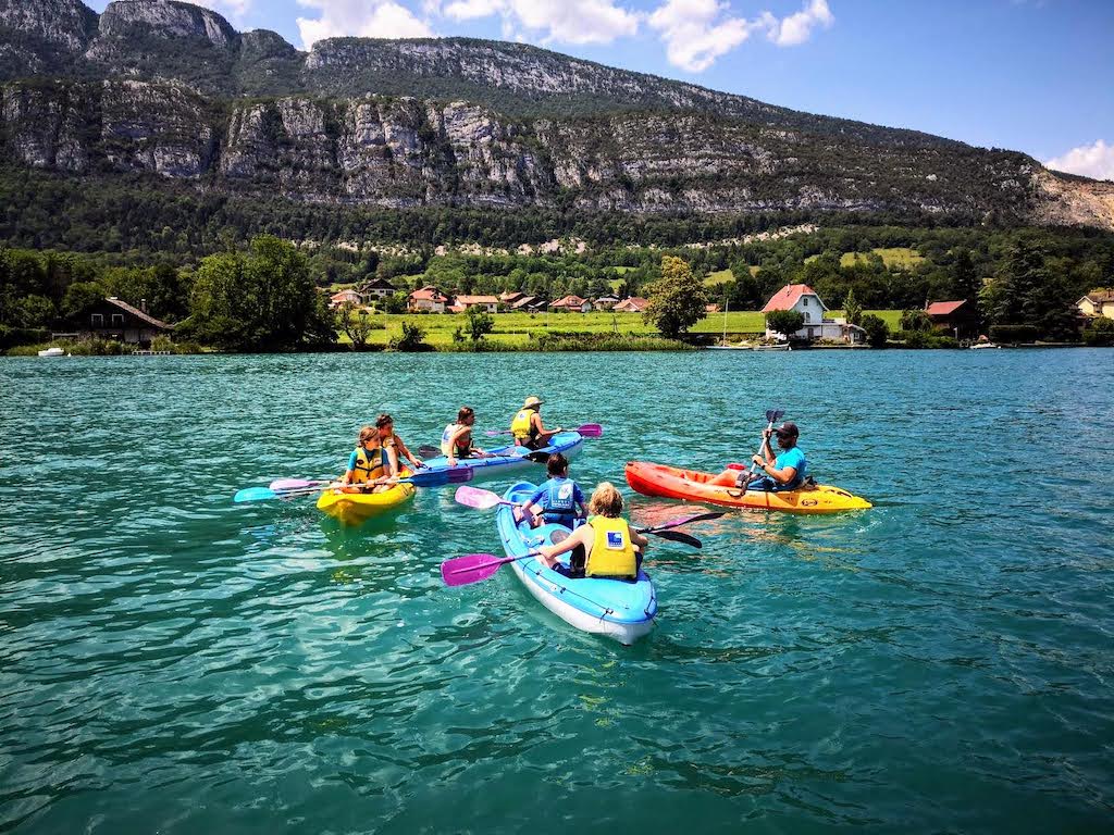 four colorful kayaks in blue water-kayaking day trips in Europe