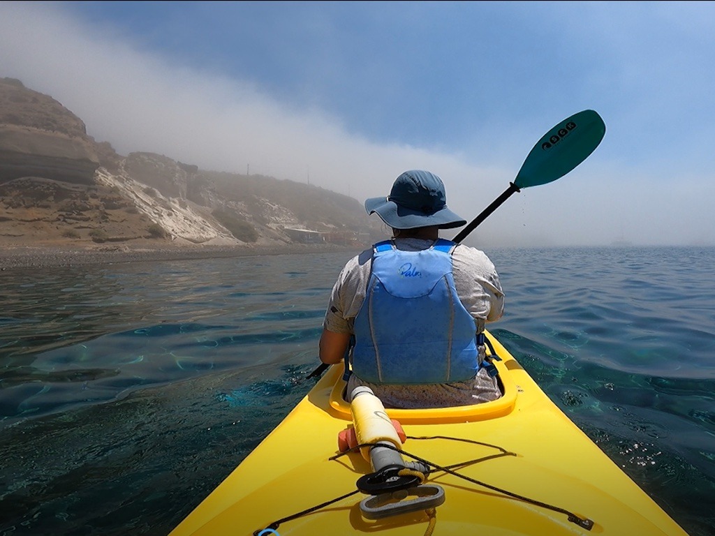 paddle with blue lifejacket kayaking in the fog-kayaking day trips in Europe