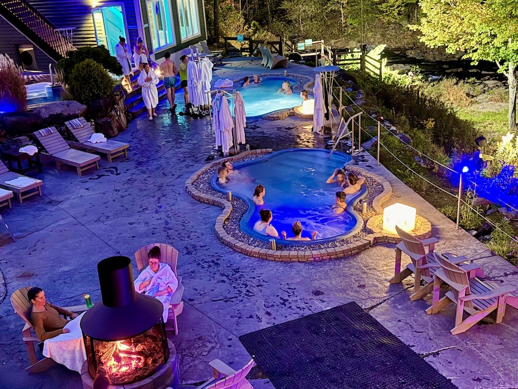 spa with people bathing and sitting by fire