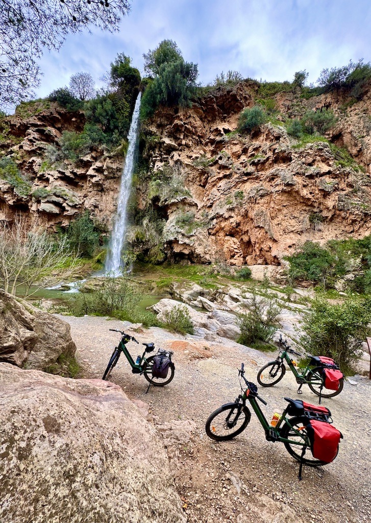 3 bikes near waterfall-biking on the Ojos Negros Greenway