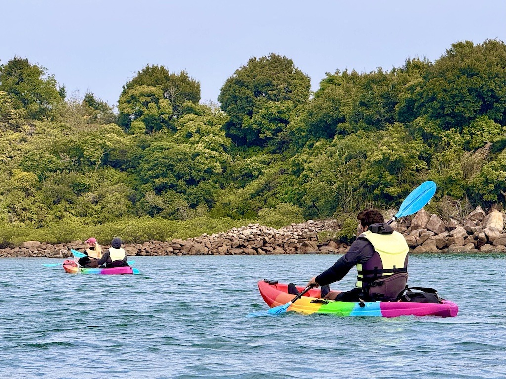 three people in two kayaks -kayaking in Sai Kung