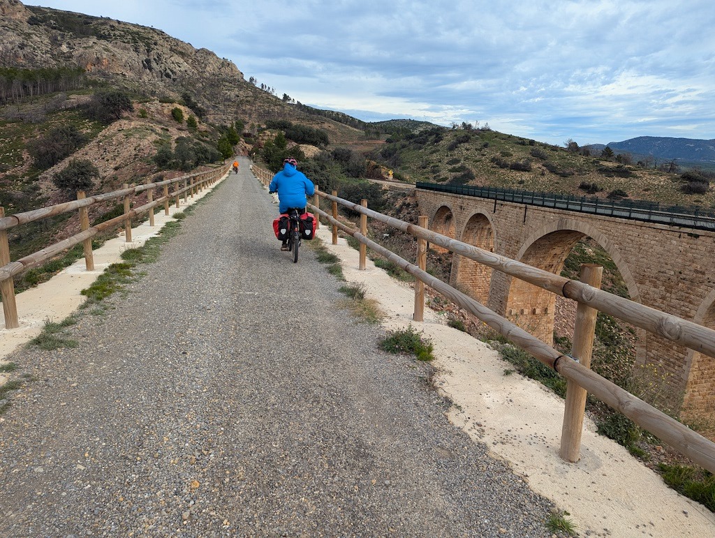 biker in blue biking on the Ojos Negros Greenway