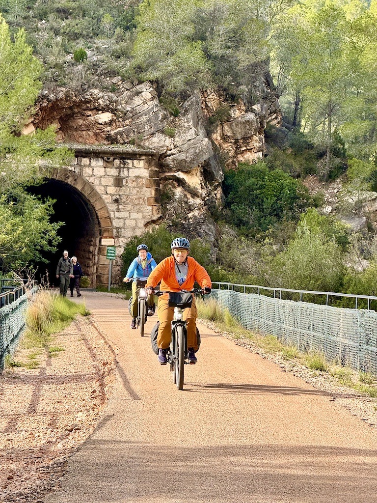 2 biking emerging from a tunnel when biking the Val del Zafán Greenway 