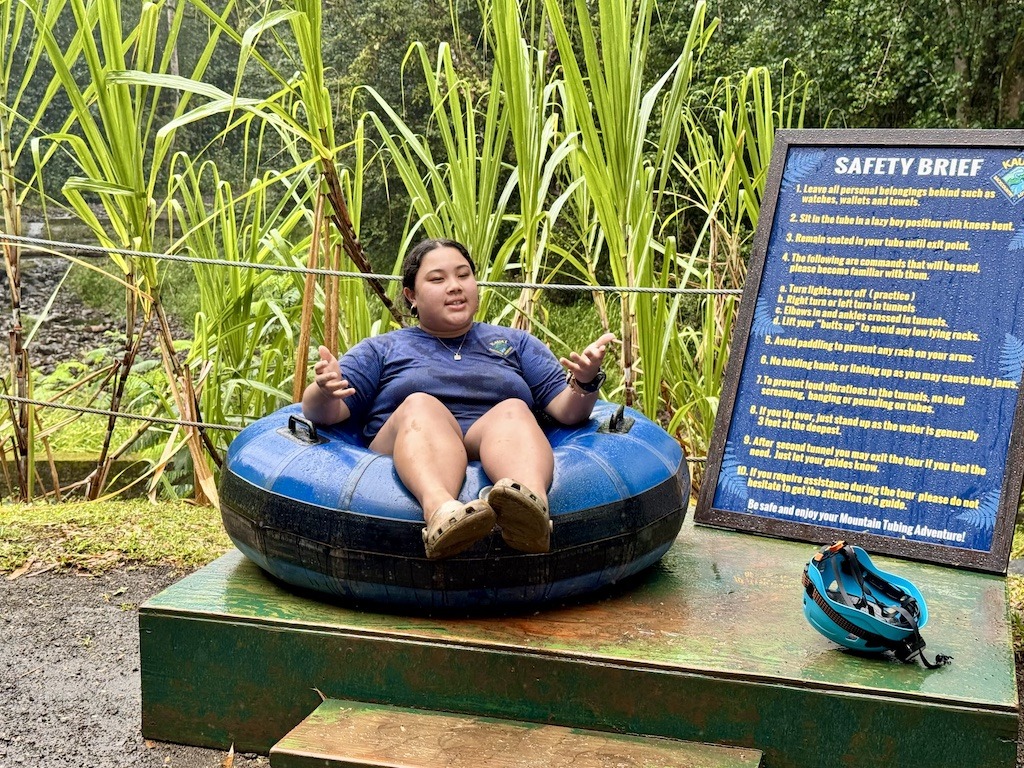 women in blue tube on land- Sugarcane Plantation Tubing in Kauai