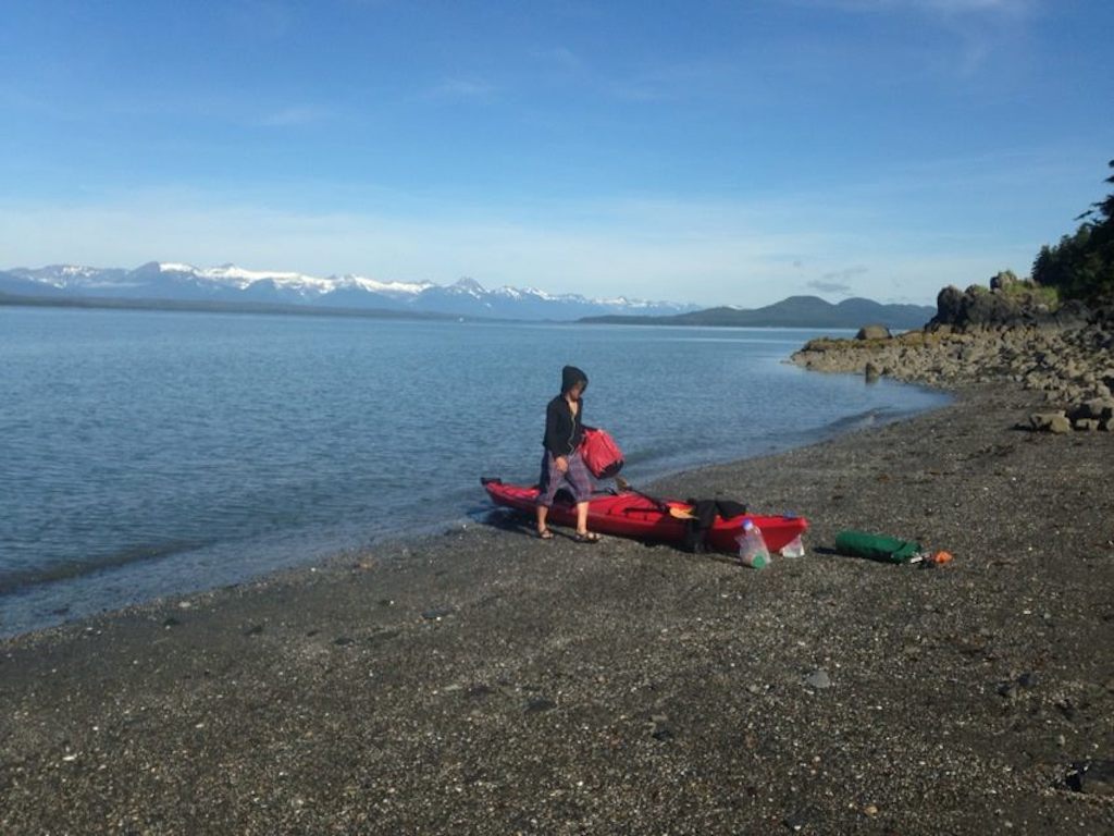 packing red kayak while sea kayaking with whales in Alaska