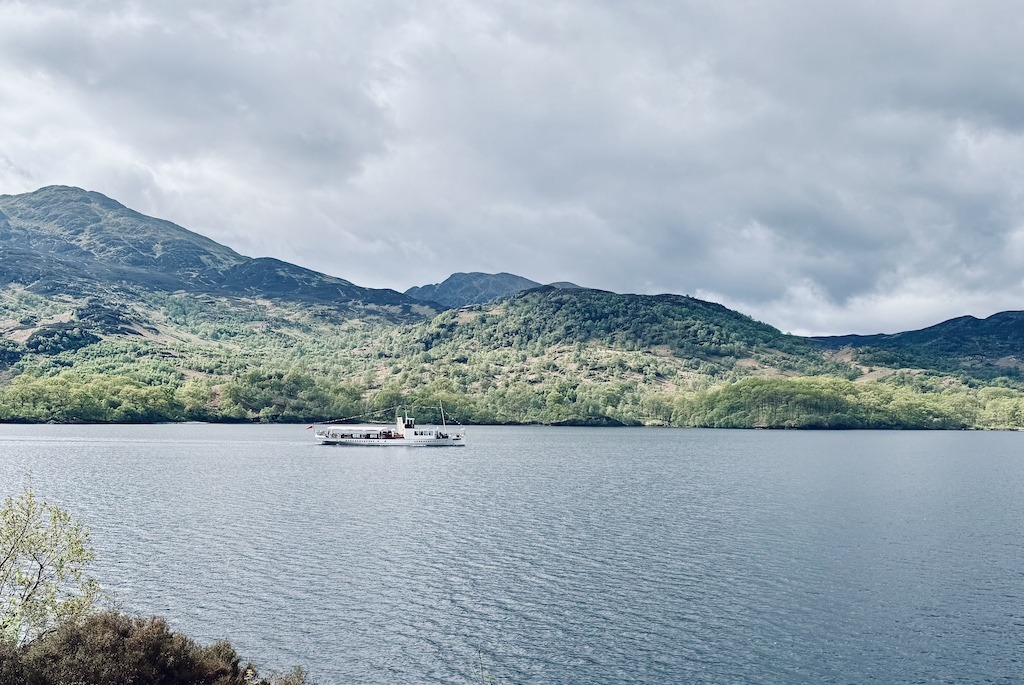 white ship crossing the loch seen while E-biking Loch Katrine