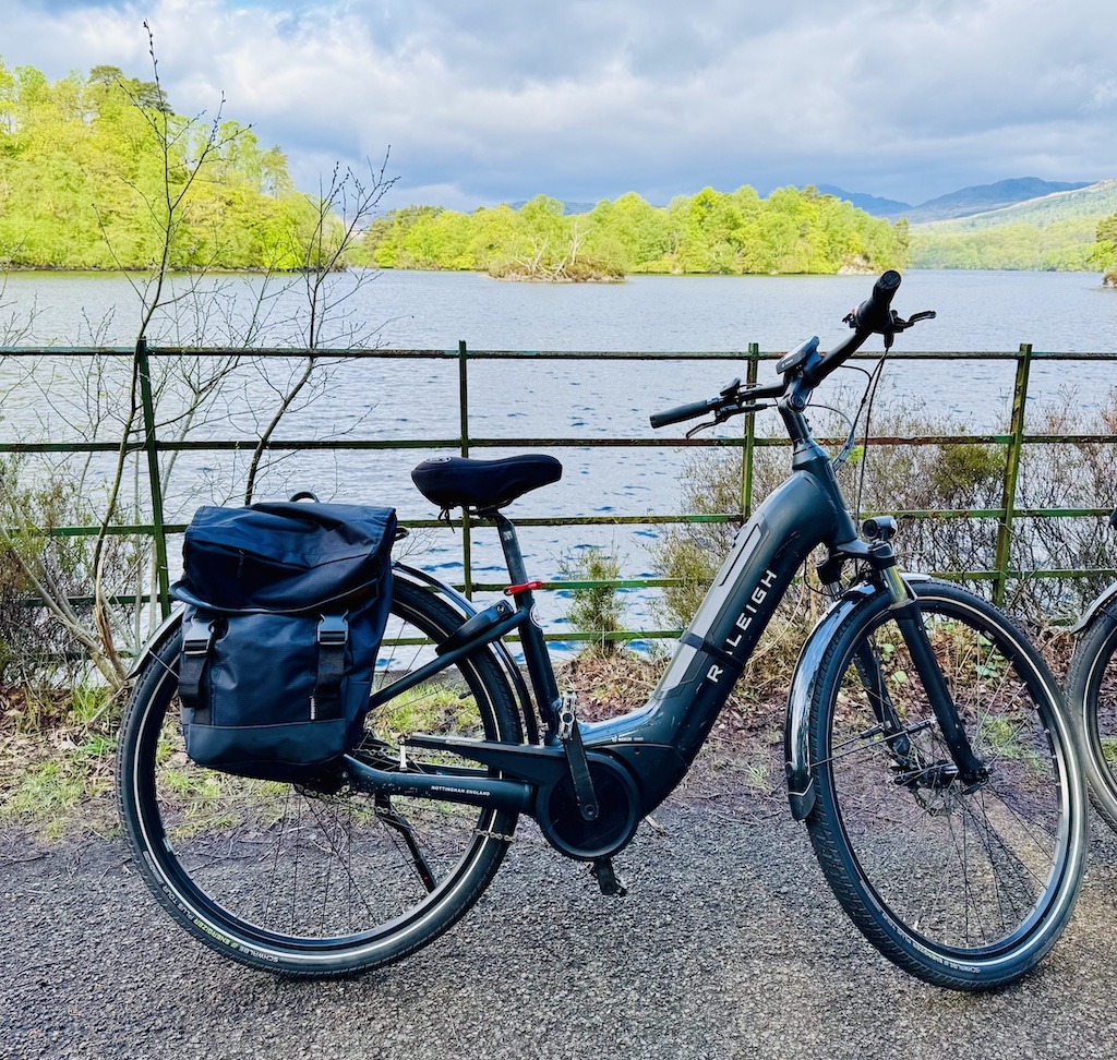 E-bike and water and fence seen E-biking Loch Katrine