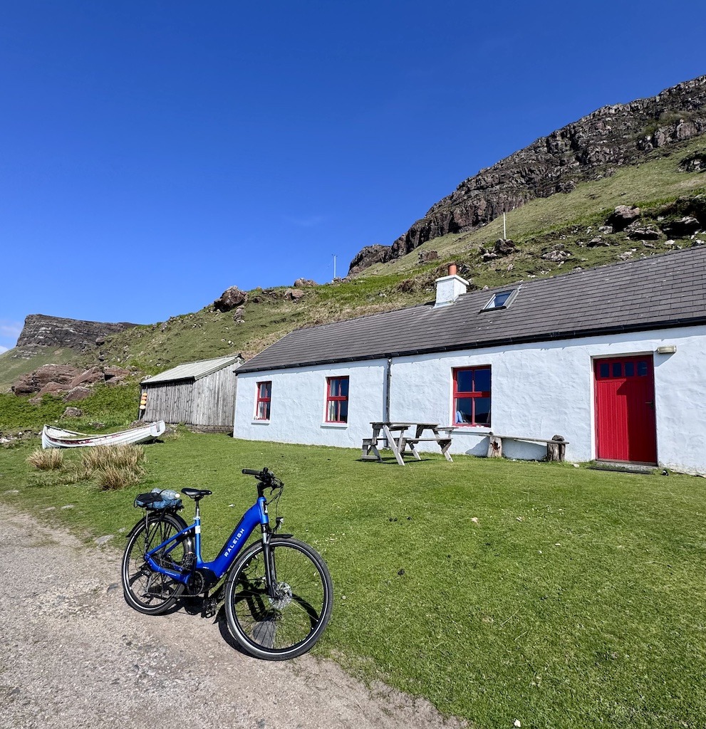 bike in front of white and red cottage