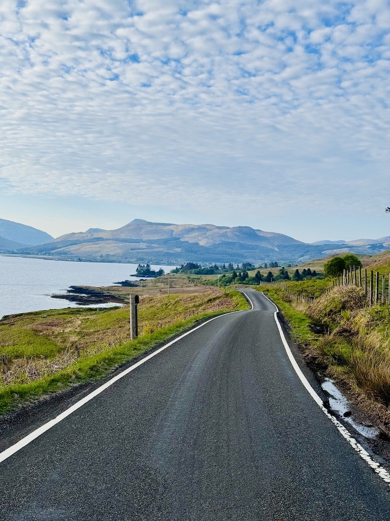 long road with mountai-outdoor adventure trip planning in Scotland