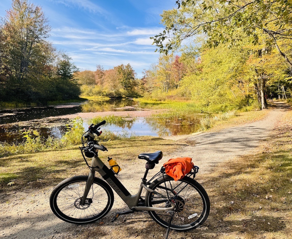 bike on trail with river in background biking in Southern New Hampshire