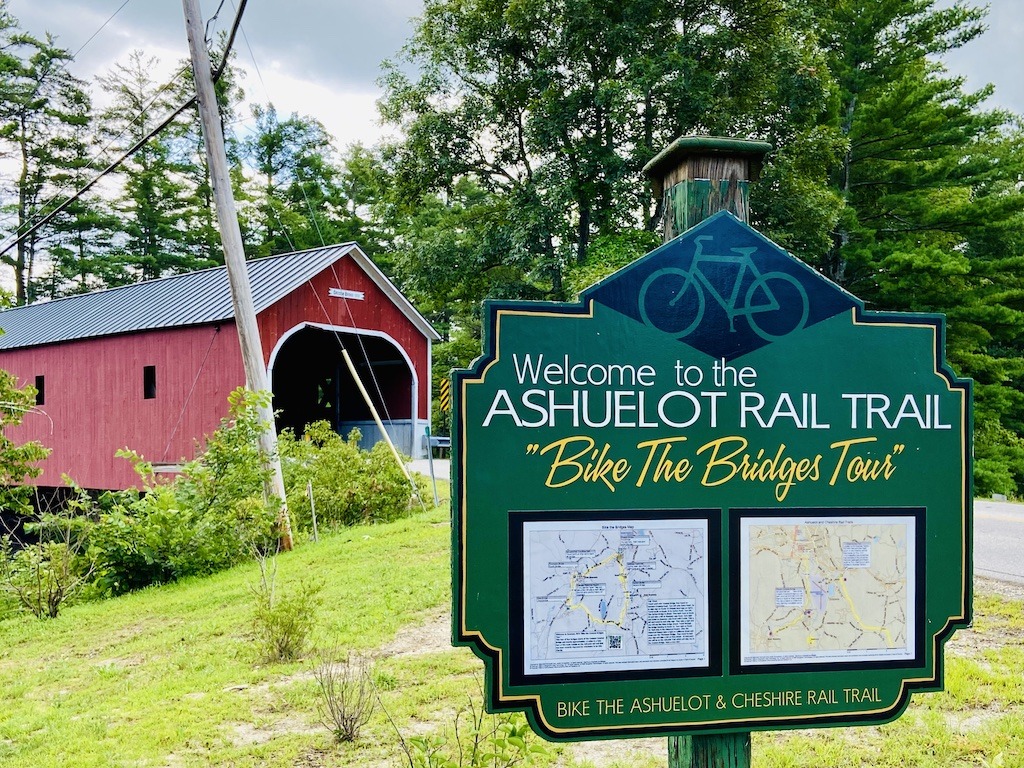 red bridge and green sign for biking in Southern New Hampshire