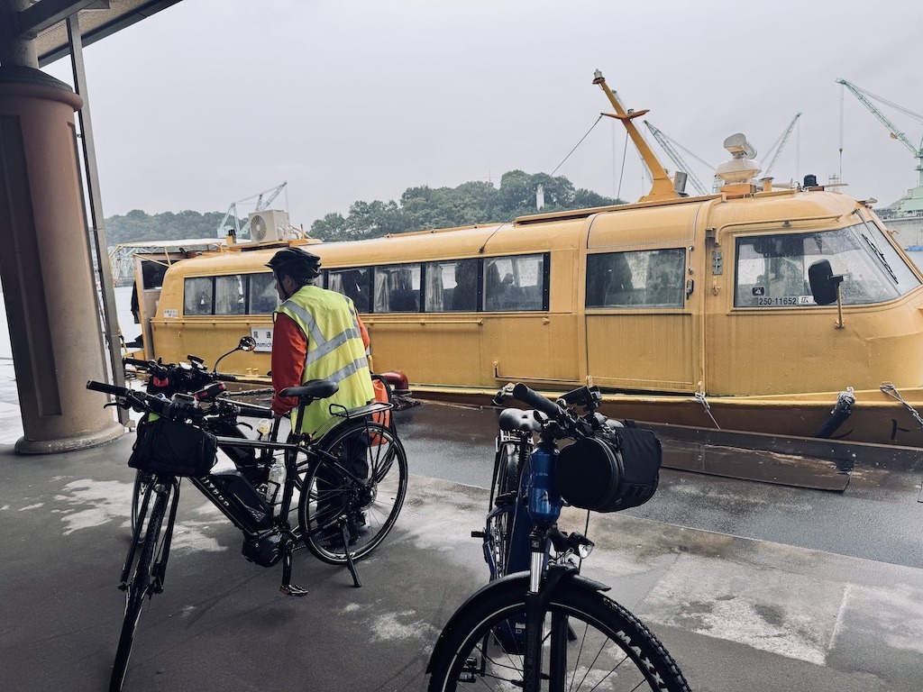 Yellow ferry boat with bikes and person while biking the Shimanami Kaido