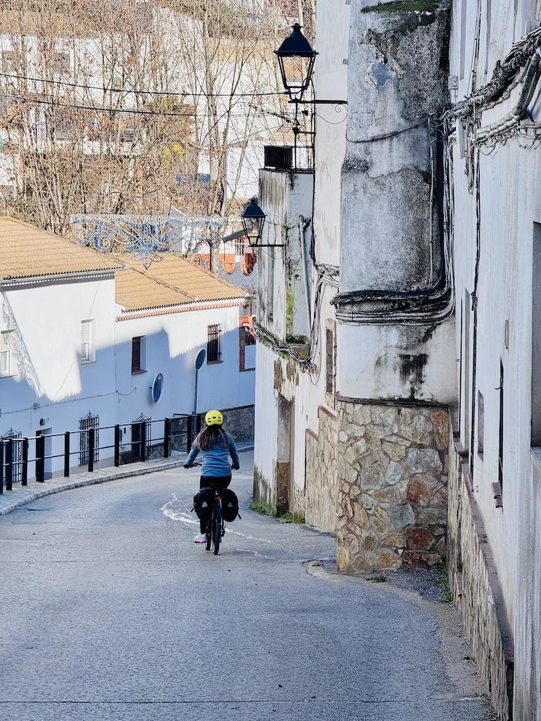 e-biking on hill in white village while doing outdoor adventures in Andalusia