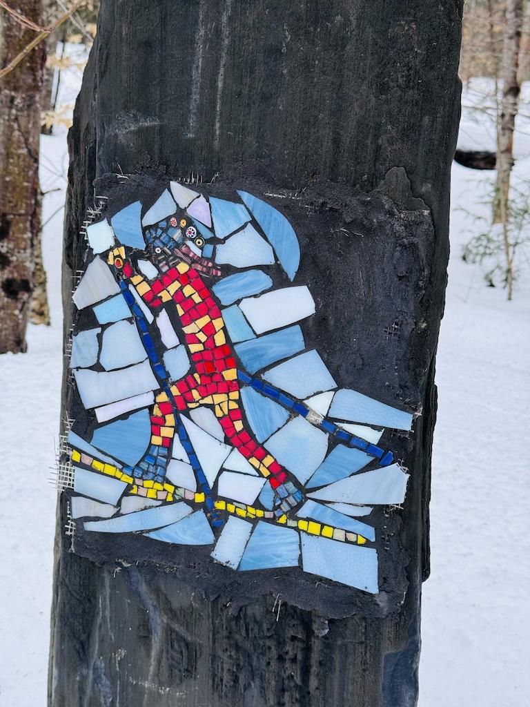red stained glass figure of a cross country skiing at Craftsbury
